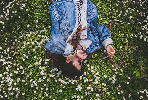 person woman lying on bed of white petaled flower human