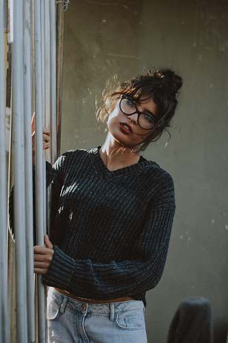 person woman wearing black framed eyeglasses human