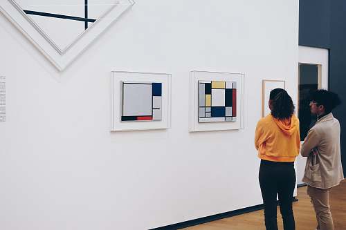 human man and woman standing facing painting inside room amsterdam