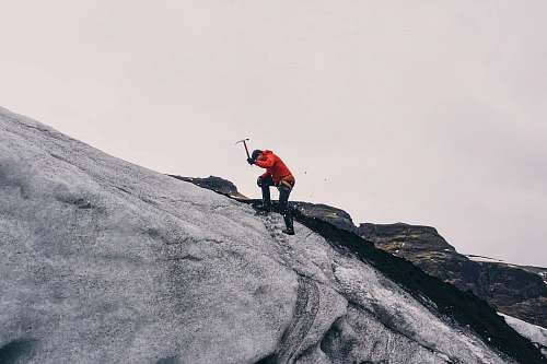 climbing man climbing on mountain during daytime human