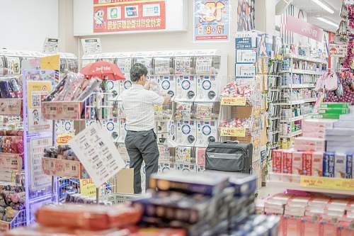 human person facing plastic packs inside store people