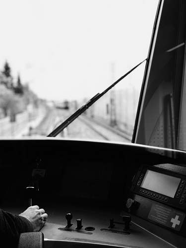 human person inside train cockpit black-and-white