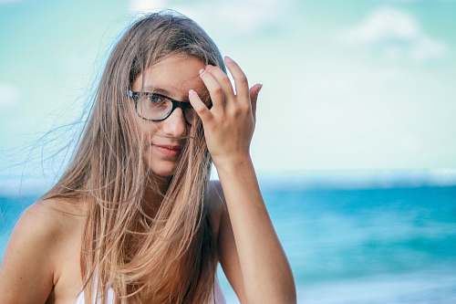 human woman wearing black framed eyeglasses in white top female
