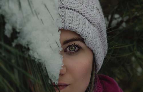 clothing woman's face covered by green plant people