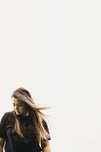 human women's black shirt under white sky apparel