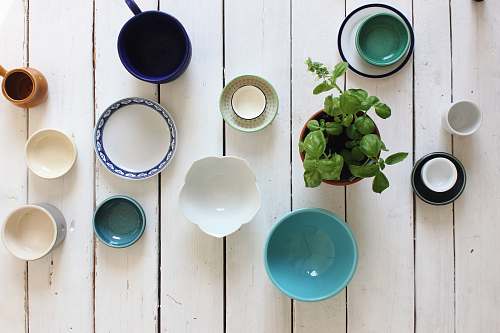 pottery assorted-color ceramic bowl on white wooden surface art