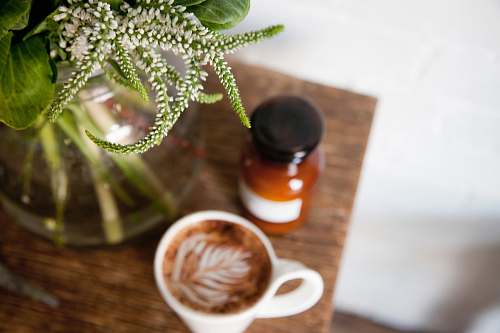 cup photo of white ceramic cup with coffee on table coffee cup