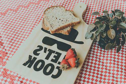 fruit two sliced breads on brown wooden chopping board strawberry