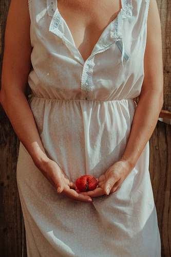 apparel unknown person holding red fruit clothing