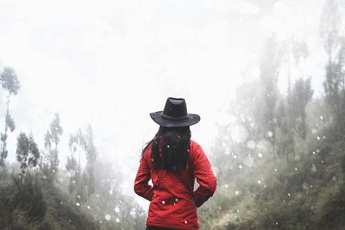 nature woman in red shirt standing near forest hat