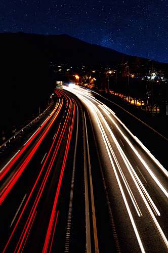 freeway timelapse photo of vehicles on road during nighttime highway