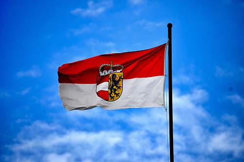 austria white and red flag on top of flagpole during daytime flag