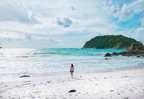 water women on shore during daytime promontory