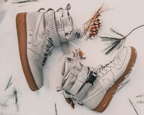 sneaker pair of gray Nike high-top sneakers on snow footwear