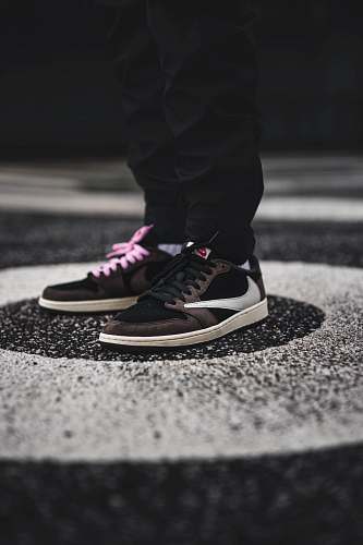 apparel person wearing brown and white Nike sneakers clothing