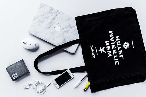 branding flat lay photography of tote bag beside iPhone and wallet gear