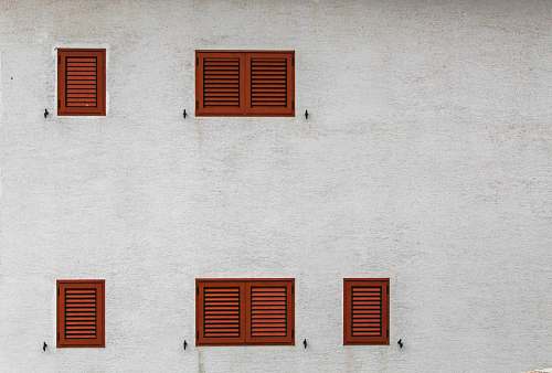 window gray building with brown louvered windows curtain