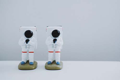 statue two spacesuit figurines on white surface toy