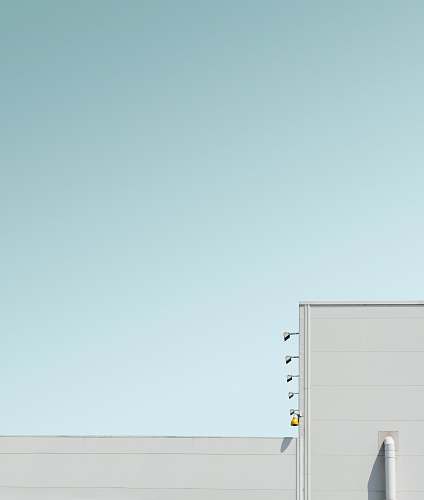 modern white concrete building under blue sky geometric