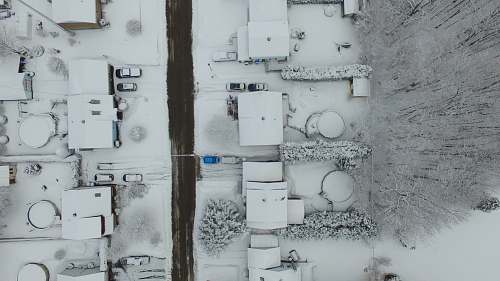 grey birds eye photography of snow covered residential area aerial view