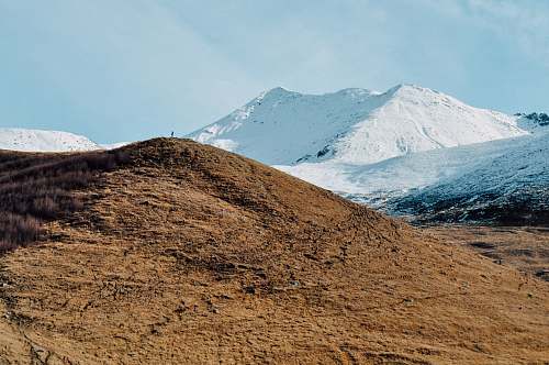 mountain brown mountain near mountain covered with snow landscape