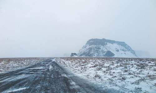 storm brown mountains covered with snow cold