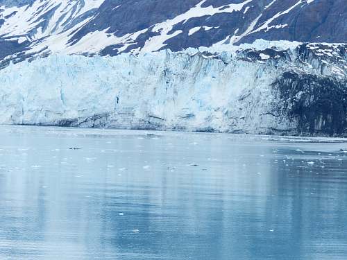 mountain mountain reflecting on body of water glacier