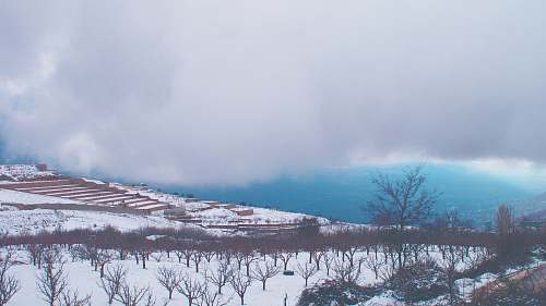 blue snow covered ground under white clouds winter