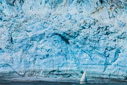 nature white sailboat near mountain glacier
