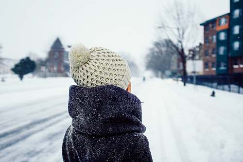 beanie woman standing on snow covered road hat