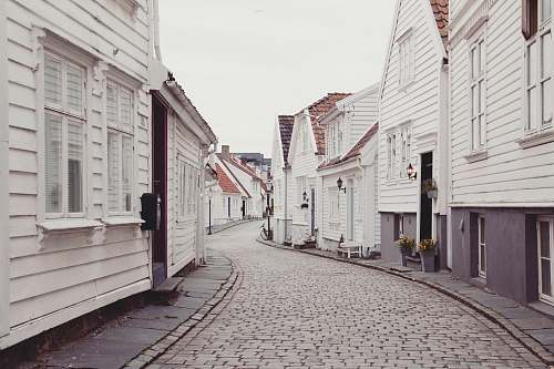 road empty roadway in between houses at daytime town