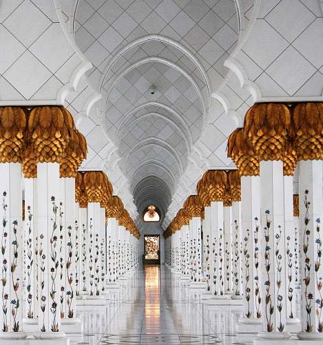 architecture photo of white columns and marble tiles mosque