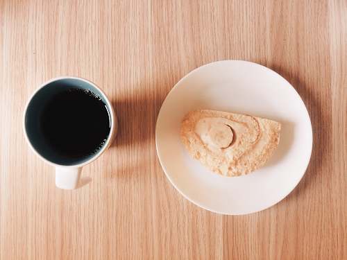 cup mug full of black coffee near a slice of cake coffee cup