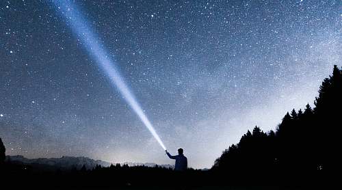 switzerland silhouette of person holding flashlight during nighttime night