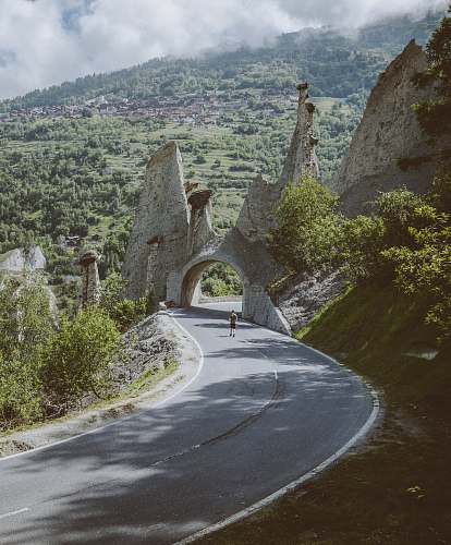 switzerland man walking on road near arch road