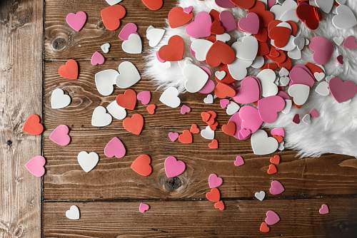 love heart-shaped assorted-color cutout decors place on wooden surface holiday