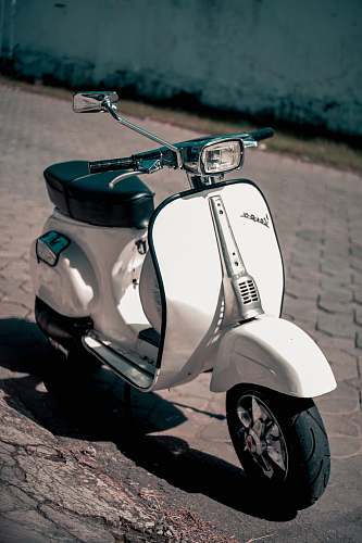 vespa white and black motor scooter scooter