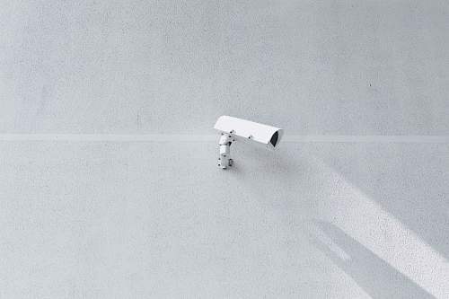 grey white box security camera on wall surveillance