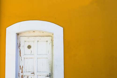 door yellow wall with white wooden door yellow