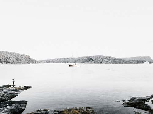 shoreline boat on body of water near island sea