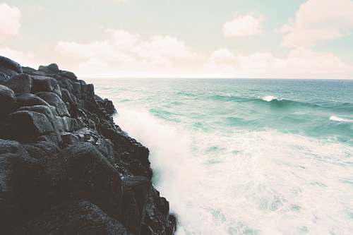 rocks rocky cliff beside the ocean grey