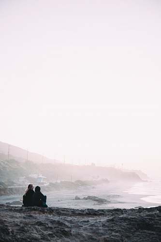 malibu two person sitting beside shore coast