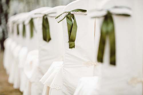 white selective focus photography of white and green chair decoration