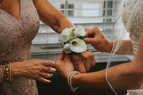 windsor woman put white flowers on woman's hand canada