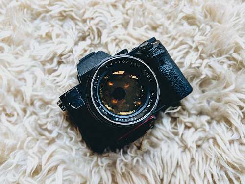 goggles black milc camera on white fur cloth minolta