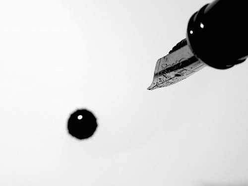 black-and-white fountain pen dripping ink black