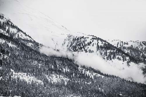 mountain grayscale photography of snowy mountain clouds