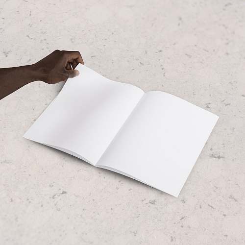 paper person holding blank book page minimal