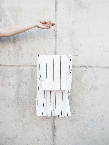 fashion person holding hanger with white shorts paper