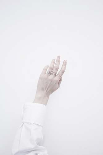 grey person's wearing several silver-colored rings ring